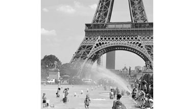 people getting sprayed with water with Eiffel tower in background